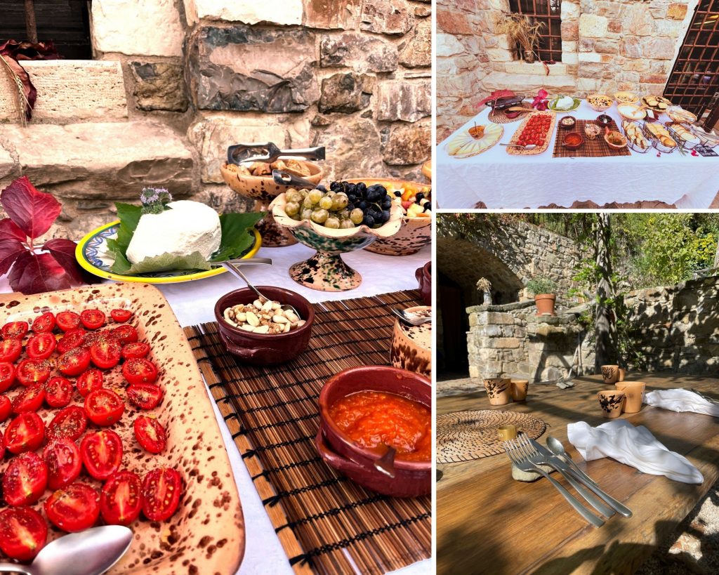 The image presents a collage of three photographs showcasing a buffet-style table, with the left photograph serving as the main focus. The table is adorned with an assortment of dishes, including cherry tomatoes, cheese, grapes, nuts, and other items, arranged on various plates and bowls. **Left Photograph:** * A large plate filled with halved cherry tomatoes * A bowl containing what appears to be cheese or a similar white substance * A small bowl holding nuts * A dish of grapes The table is set against a backdrop of stone walls, likely made from limestone or sandstone, and features a wooden floor. The overall atmosphere suggests an outdoor setting, possibly in a garden or courtyard. **Top Right Photograph:** * A close-up view of the buffet table, showcasing its contents * A white tablecloth covering the table * Various dishes arranged on top of the table This photograph provides a more detailed look at the food and presentation style of the buffet. **Bottom Right Photograph:** * An empty outdoor seating area with wooden benches or tables * The same stone walls visible in the left photograph can be seen in the background * A few decorative items, such as small pots or vases, are placed on the table This photograph suggests that the event is taking place in a designated dining area, possibly with additional amenities like restrooms or storage facilities. **Overall:** The image presents a warm and inviting atmosphere, evoking feelings of hospitality and community. The use of natural materials, such as stone walls and wooden floors, adds to the rustic charm of the setting. The abundance of food on display implies that the event is a celebratory occasion, perhaps a wedding or anniversary party.